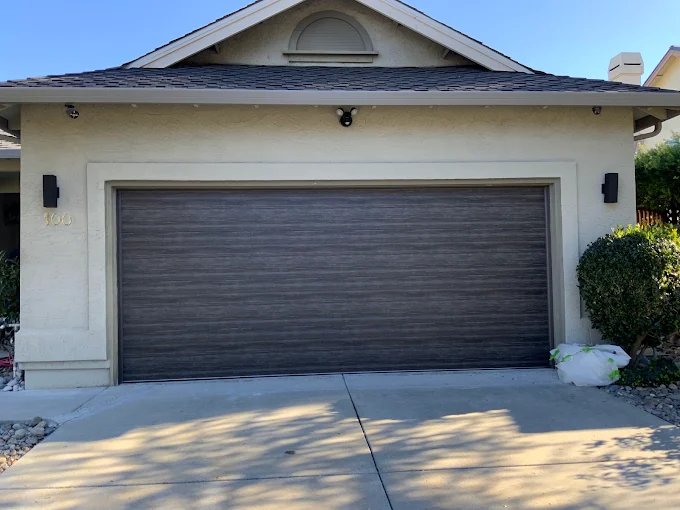 Dark wood-look garage door on a single-story home